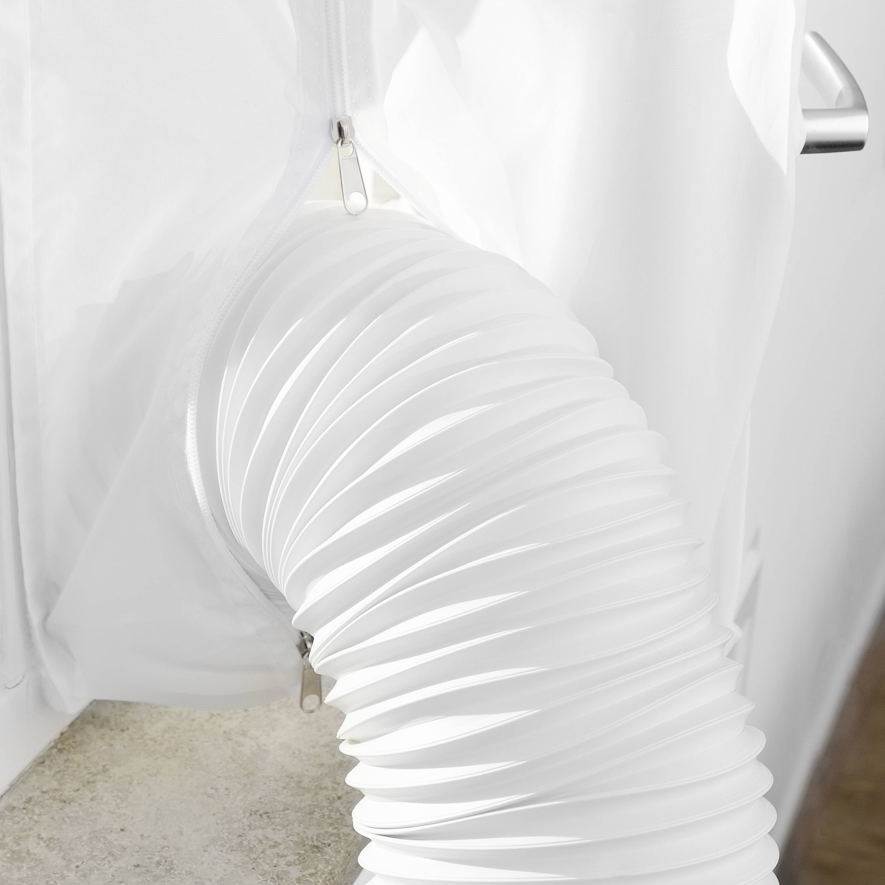 A white pipe from a dehumidifier is connected to a window. It directs warm air outside.