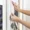 Hands applying a white sealing strip to a window frame to improve weatherproofing and insulation.