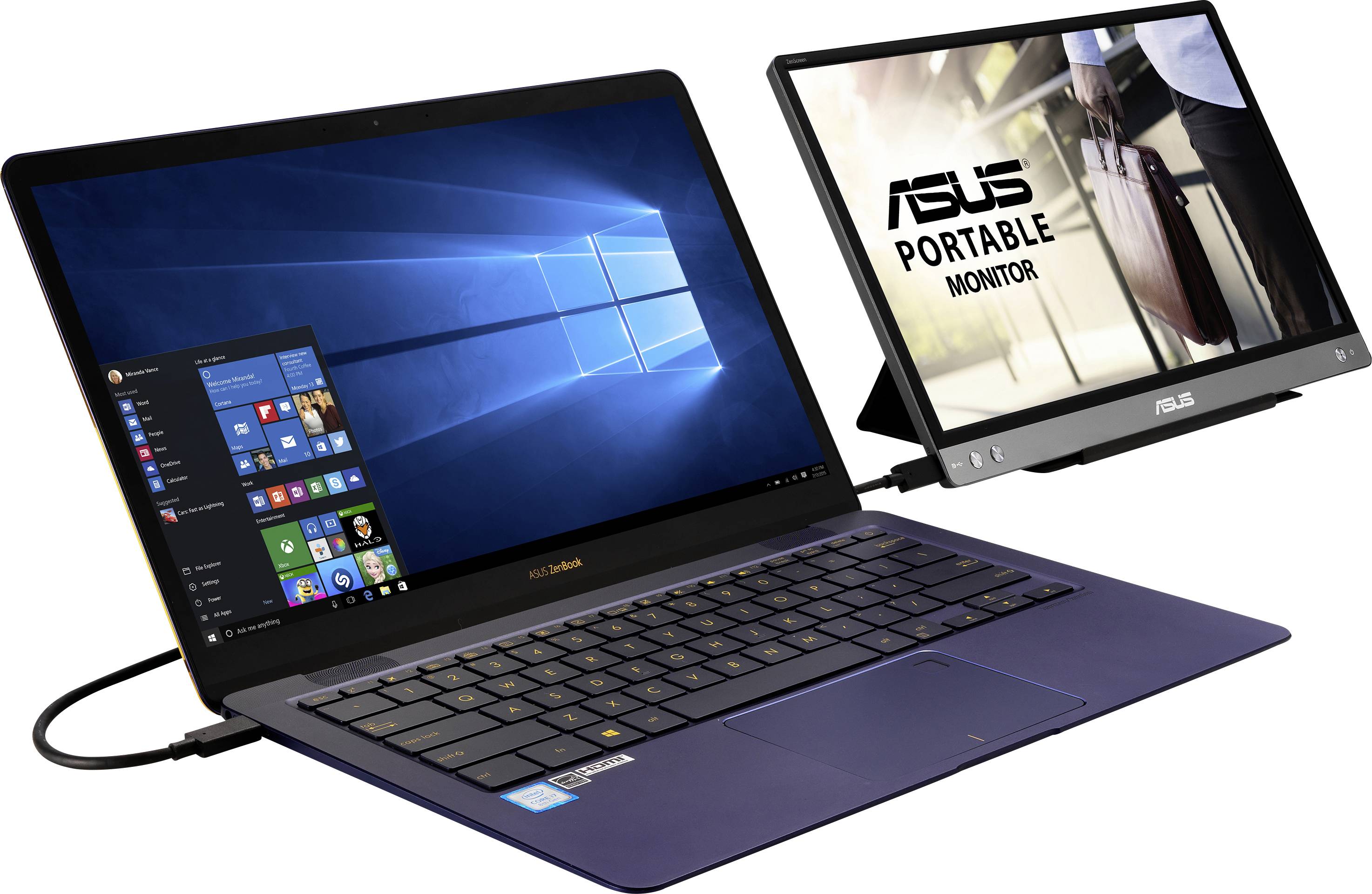 A laptop running Windows is connected to a portable ASUS monitor. The monitor displays a business person.
