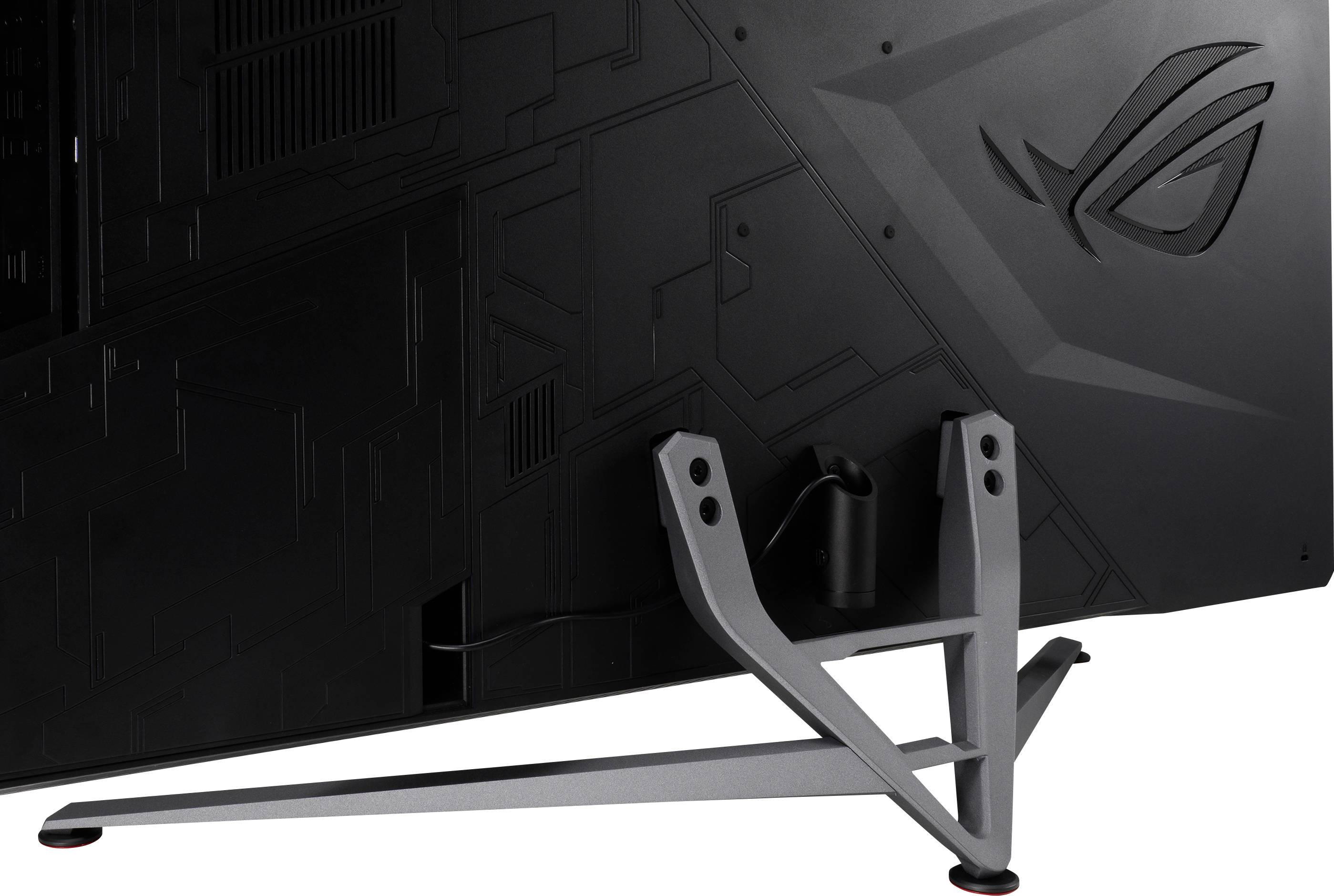 The back of a monitor featuring a stylised logo and a distinctive three-legged stand mounted on a robust base.