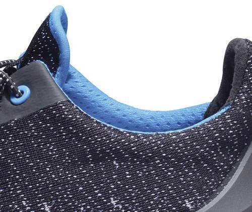 Close-up of a sports shoe in navy blue with light blue accents and laces.