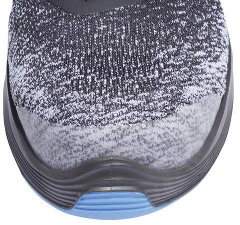 A grey and black knitted sports shoe with a rounded toe and blue sole is shown from above.