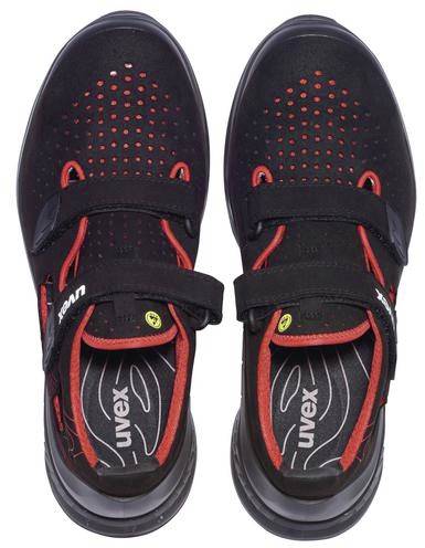 A pair of black shoes with red details, upper Velcro fastenings and perforated surface.