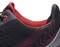 Black and red sports trainer, close-up of the shoe collar and side design with red contour lines.
