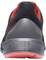 A black sports trainer viewed from behind with an orange-red sole and red accents inside.