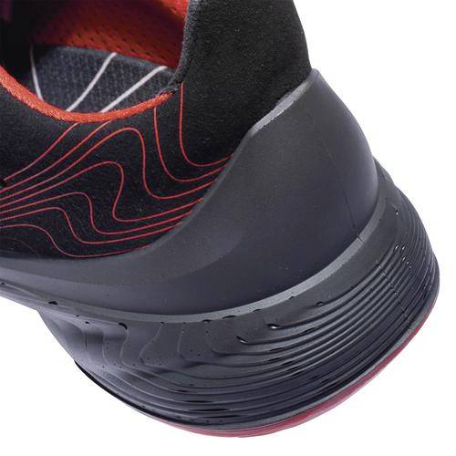 A black sports trainer with red details and a wave-like pattern. The sole is thick and has a textured surface for improved grip.