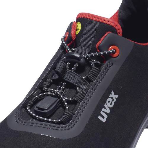 A black sports trainer with a red trim and laces. The 'uvex' brand is visible on the side.