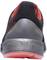 Black trainer with red sole, rear view. Minimalist design with red accents, suitable for sporting activities.