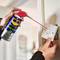 'A person sprays WD-40 Specialist Contact Cleaner onto a light switch to remove dirt.'