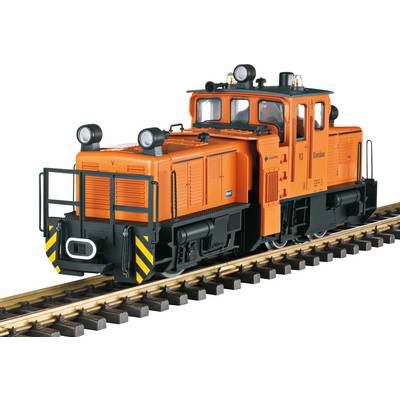 An orange locomotive on railway tracks. It has four headlights, black safety stripes, and is designed for shunting operations.