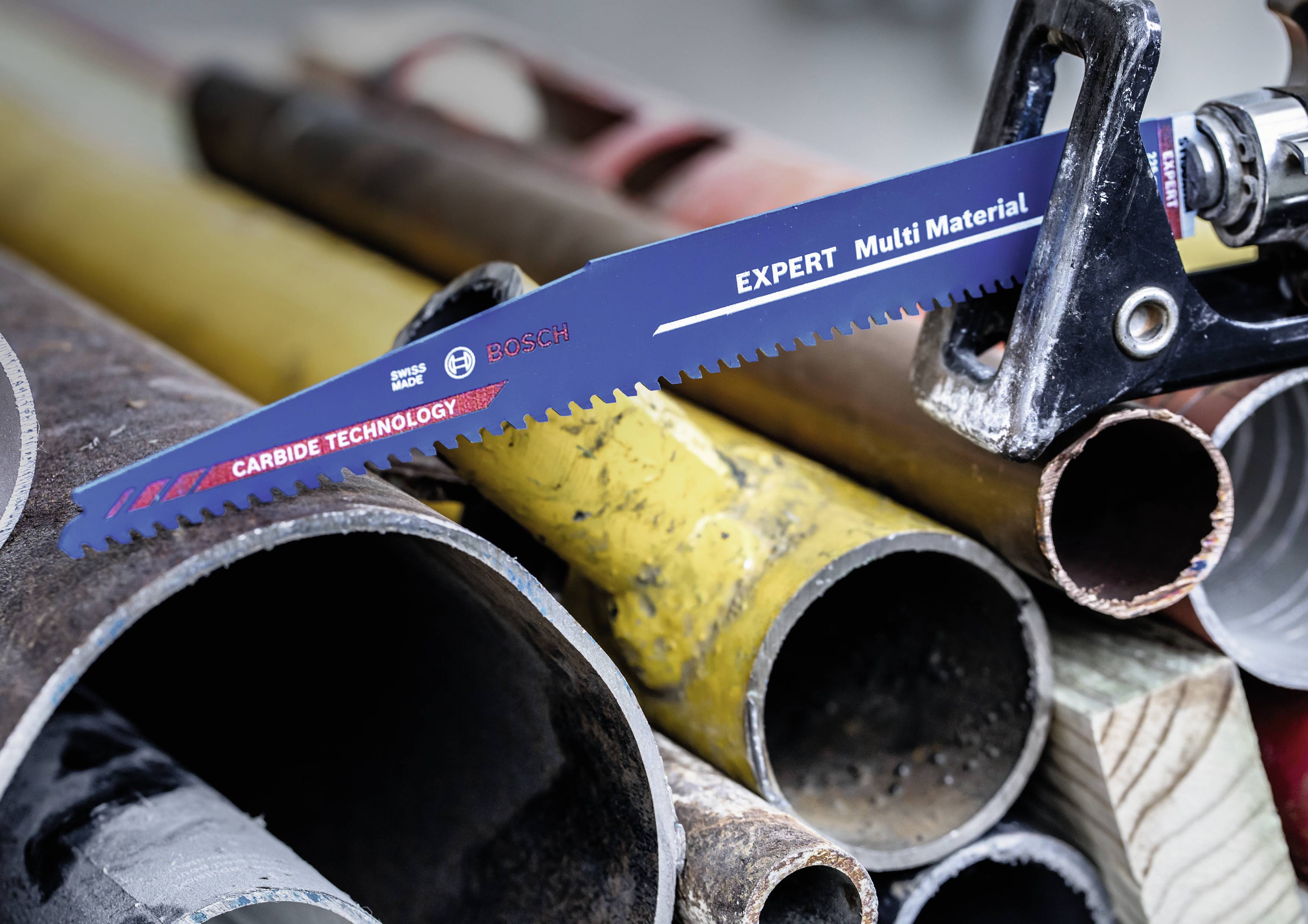 Bosch 'EXPERT Multi Material' reciprocating saw blade cuts through various pipes, including metal and plastic pipes.