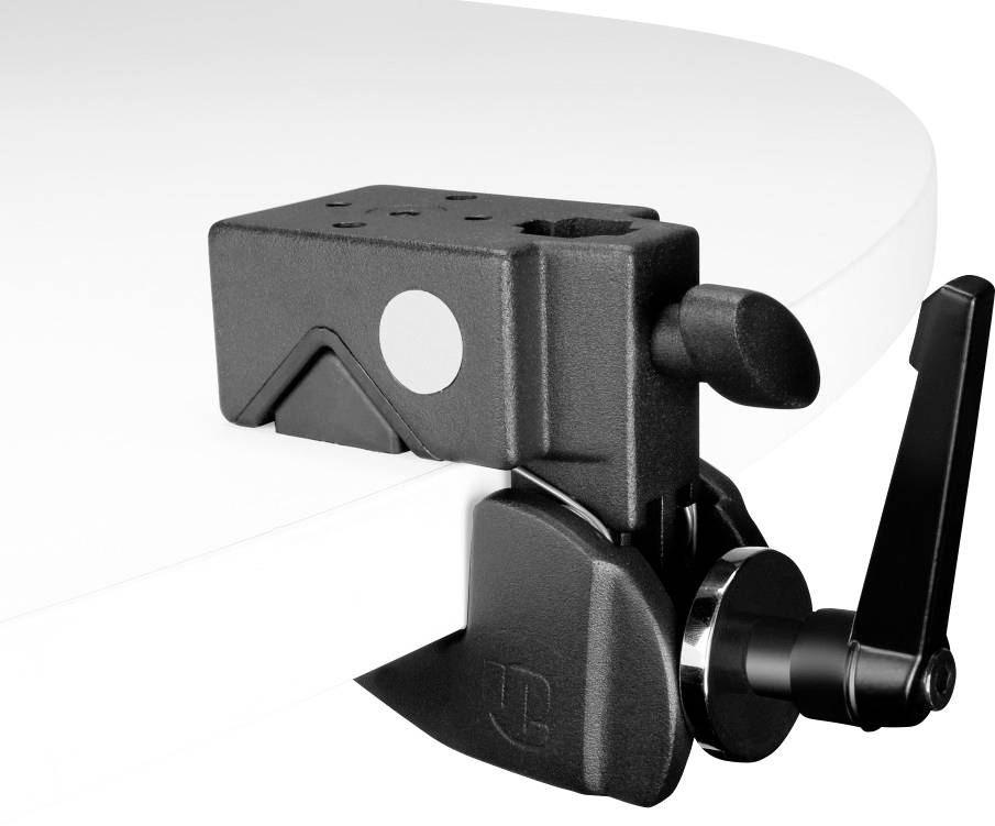 Black desk clamp attached to a white desk surface. It has a lever for adjustment and is used for fastening.