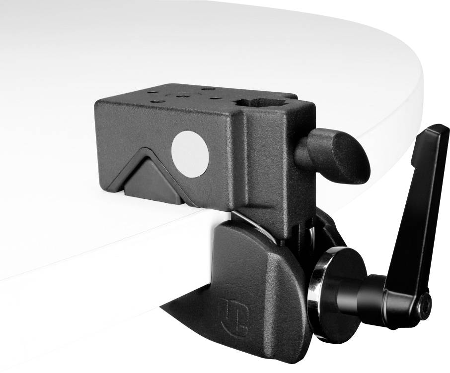 Black metal desk clamp, attached to a white desk edge, with a lever and hole for securing accessories.