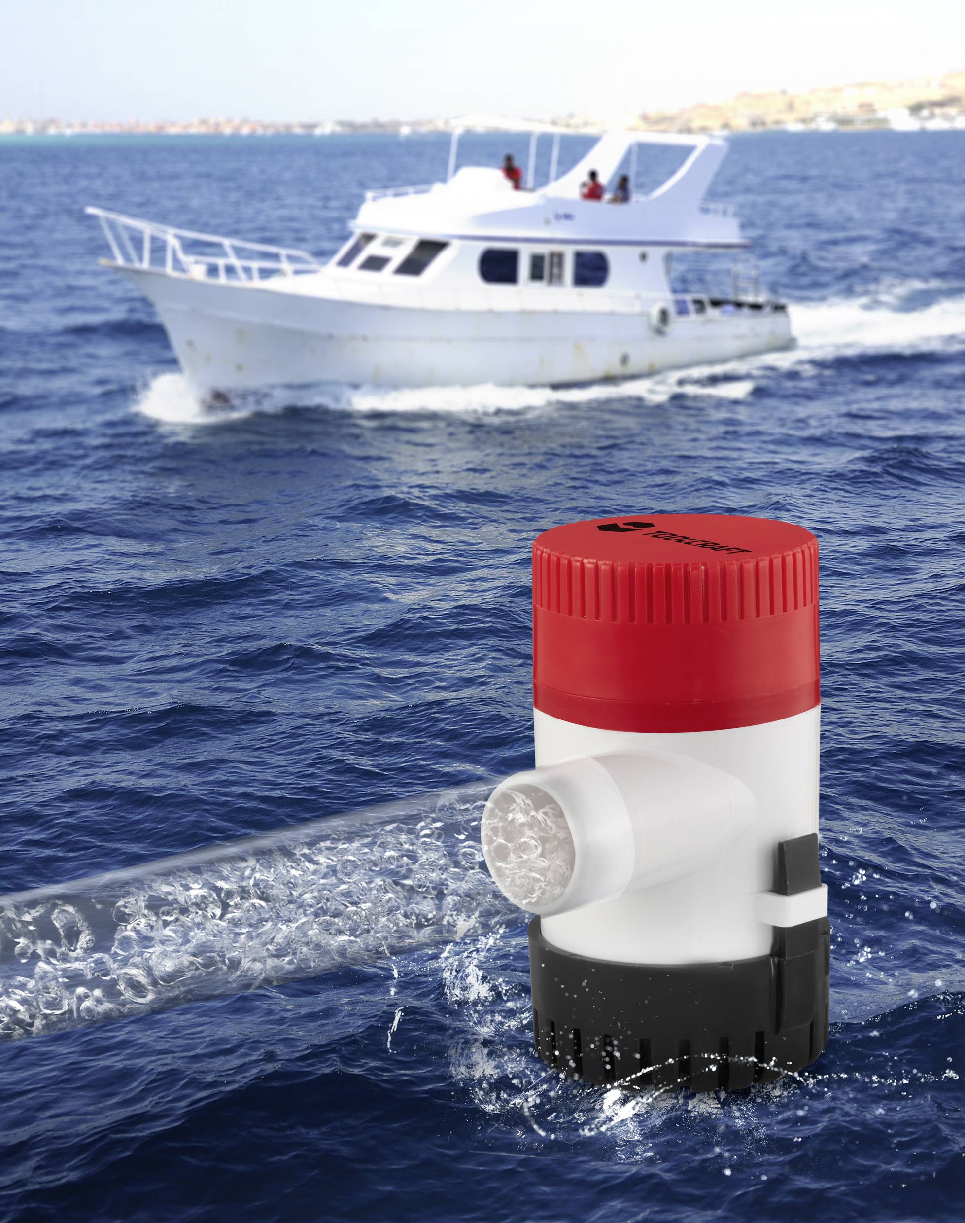 An electric water pump in operation in front of a white motorboat on the sea, which has a siren on board.