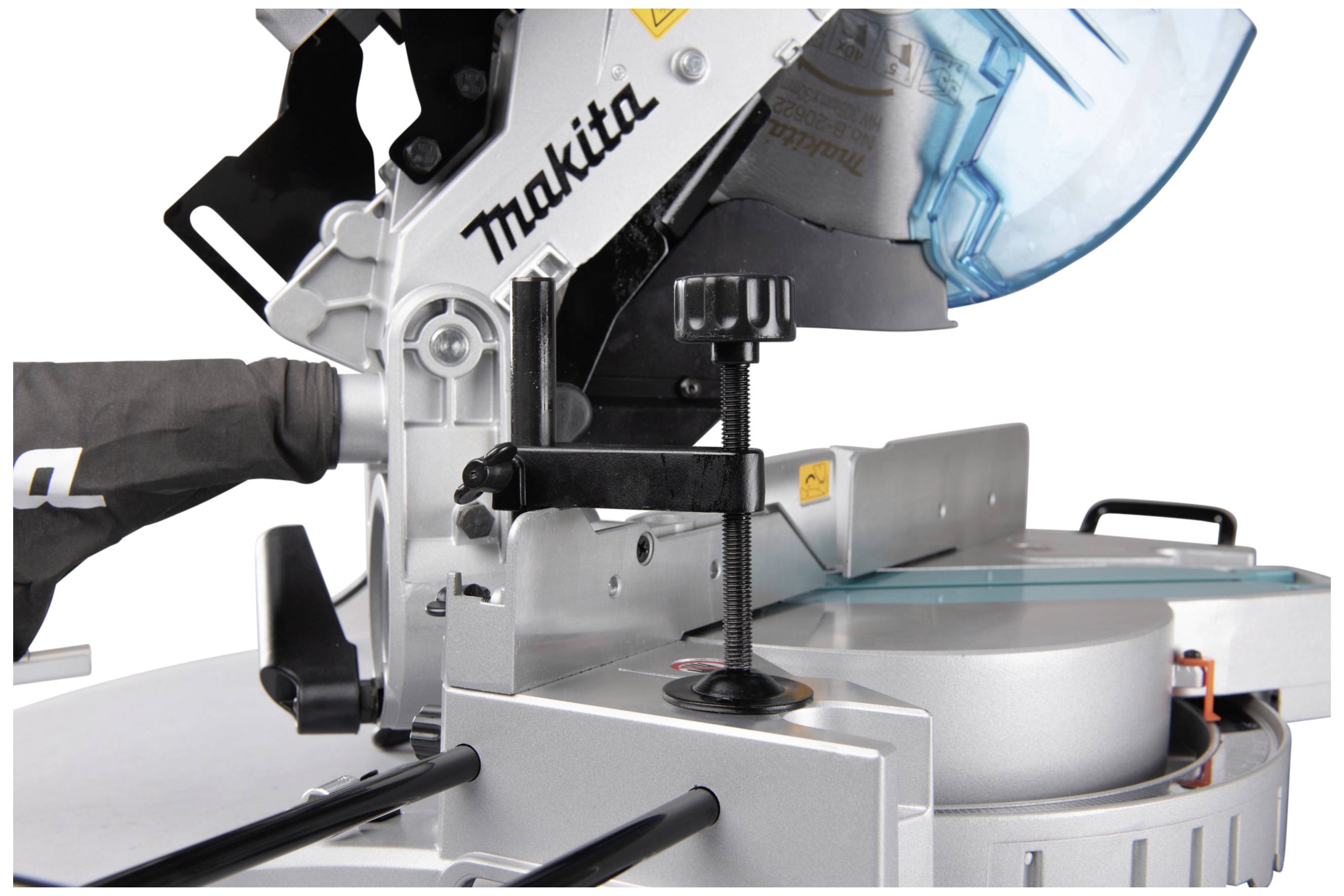 A chop saw with a blue protective housing, a saw blade, and a clamp for securing the material.