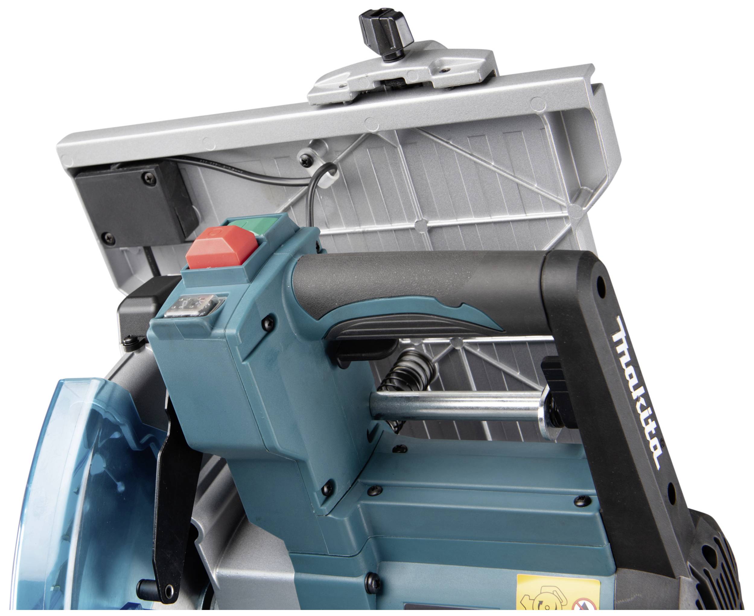 An electric circular saw with a black handle, green safety cover, and emergency stop switch, set against a metallic background.