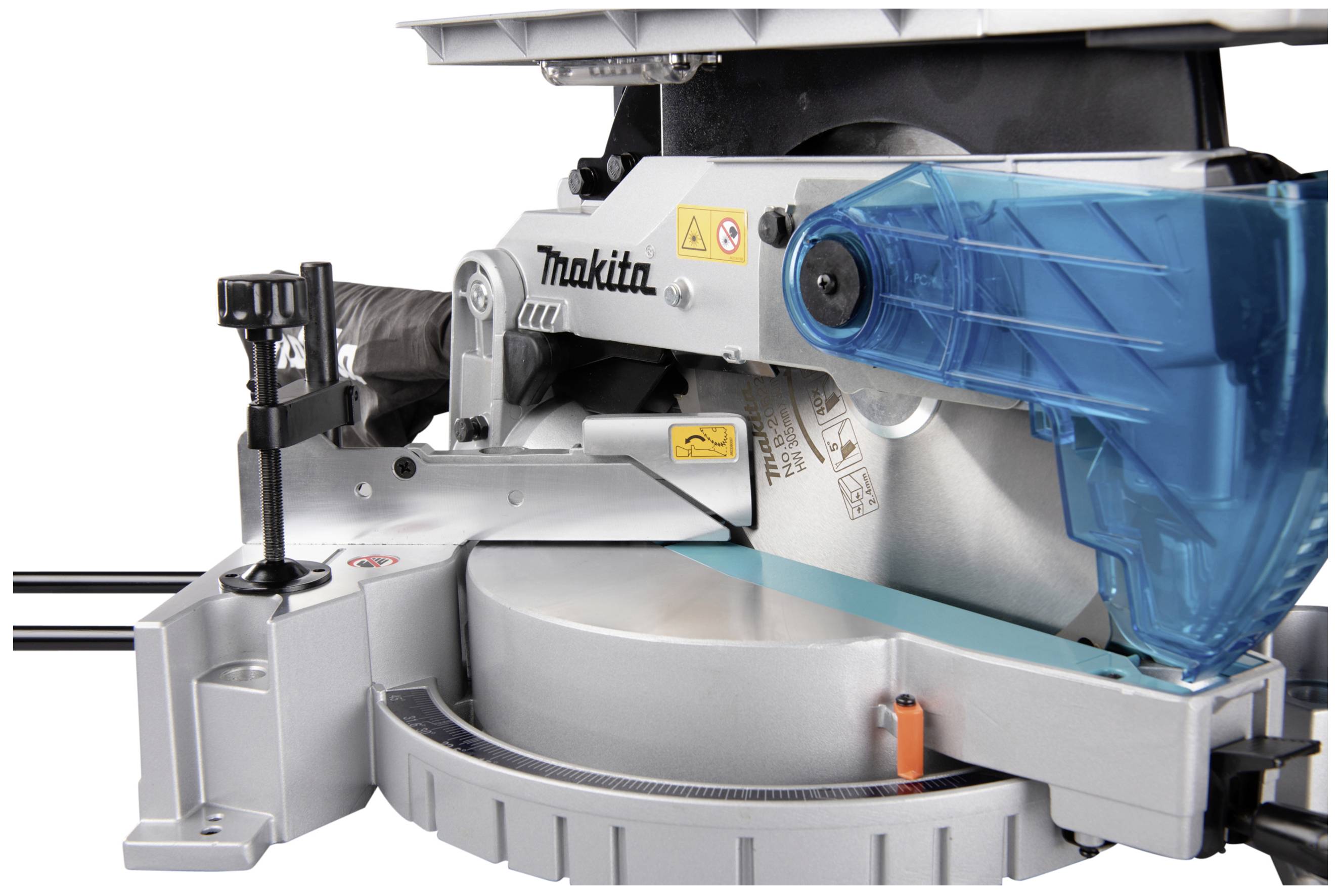 A blue angle grinder on a table. The machine has safety markings and a blue guard.