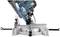 Image of a mitre saw, angled for a cut. Technical details such as the safety guard and connections are visible.