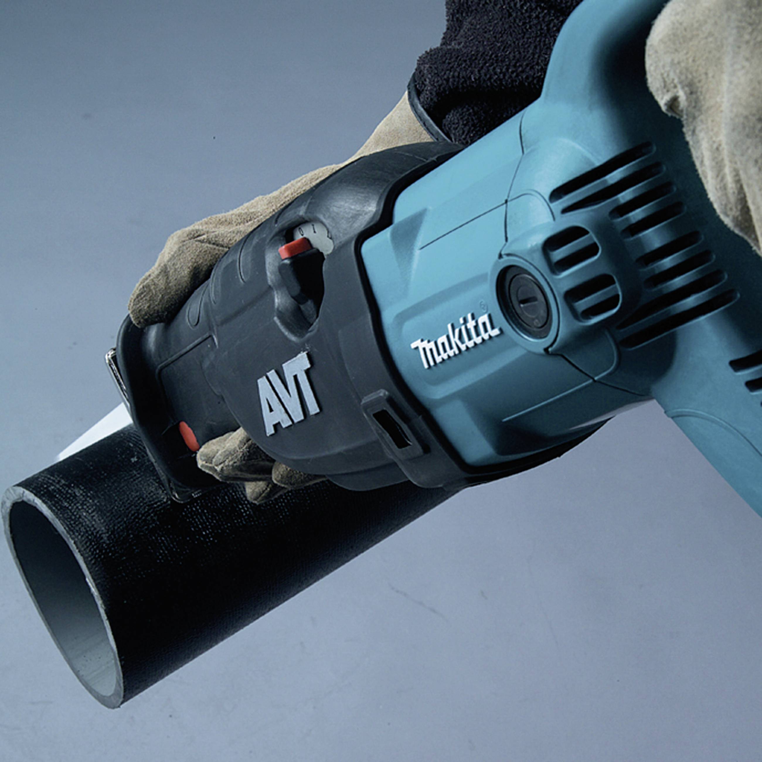 A person is wearing gloves and holding a blue electric saw with a black pipe. Brand name visible.