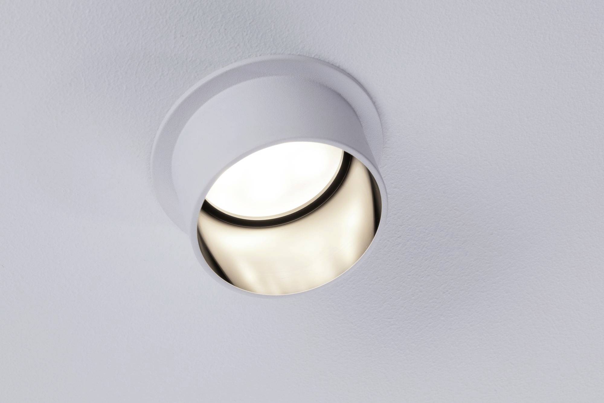 Ceiling spotlight recessed into the ceiling with a modern, white fitting.