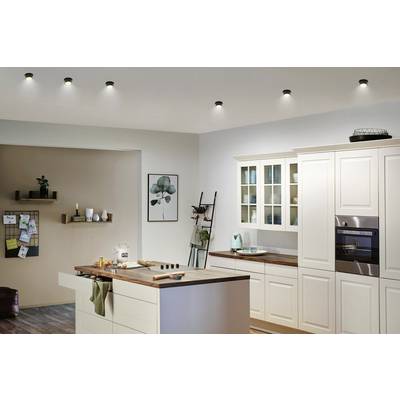 Modern kitchen with cream-coloured cabinets, integrated appliances, and a central island with a wooden worktop.