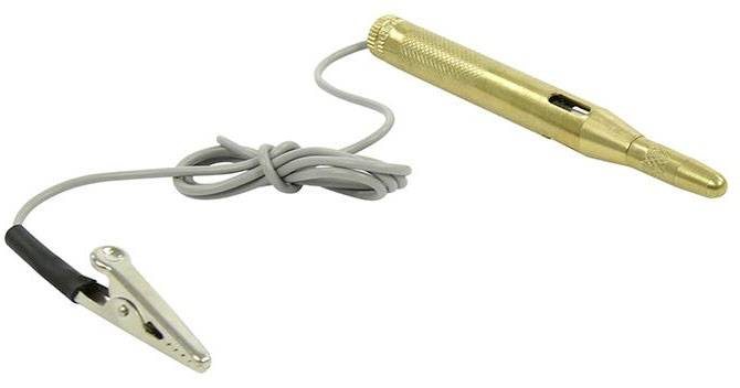 A golden voltage tester with crocodile clip and grey cable. Used for testing electrical connections.