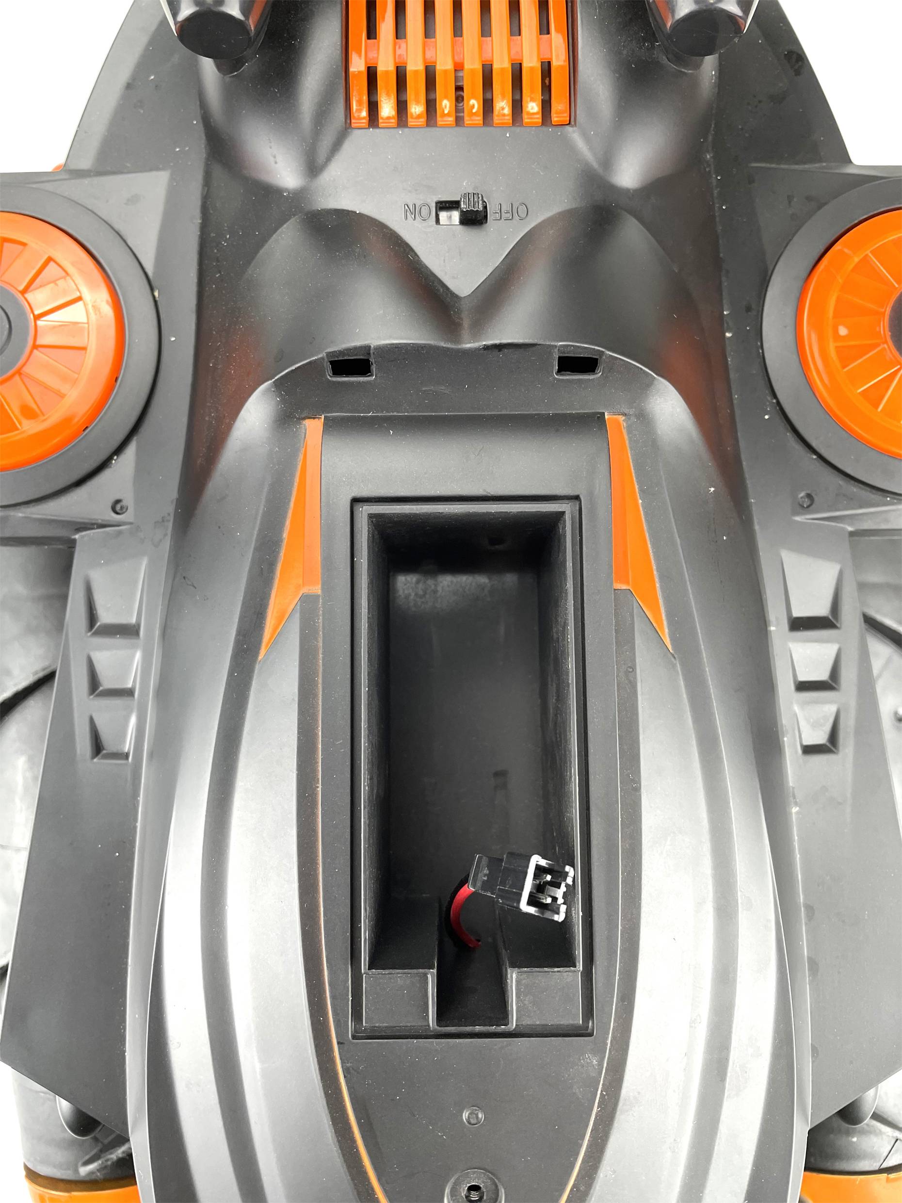 Black and orange electrical device with a central recessed opening and a protruding plug.