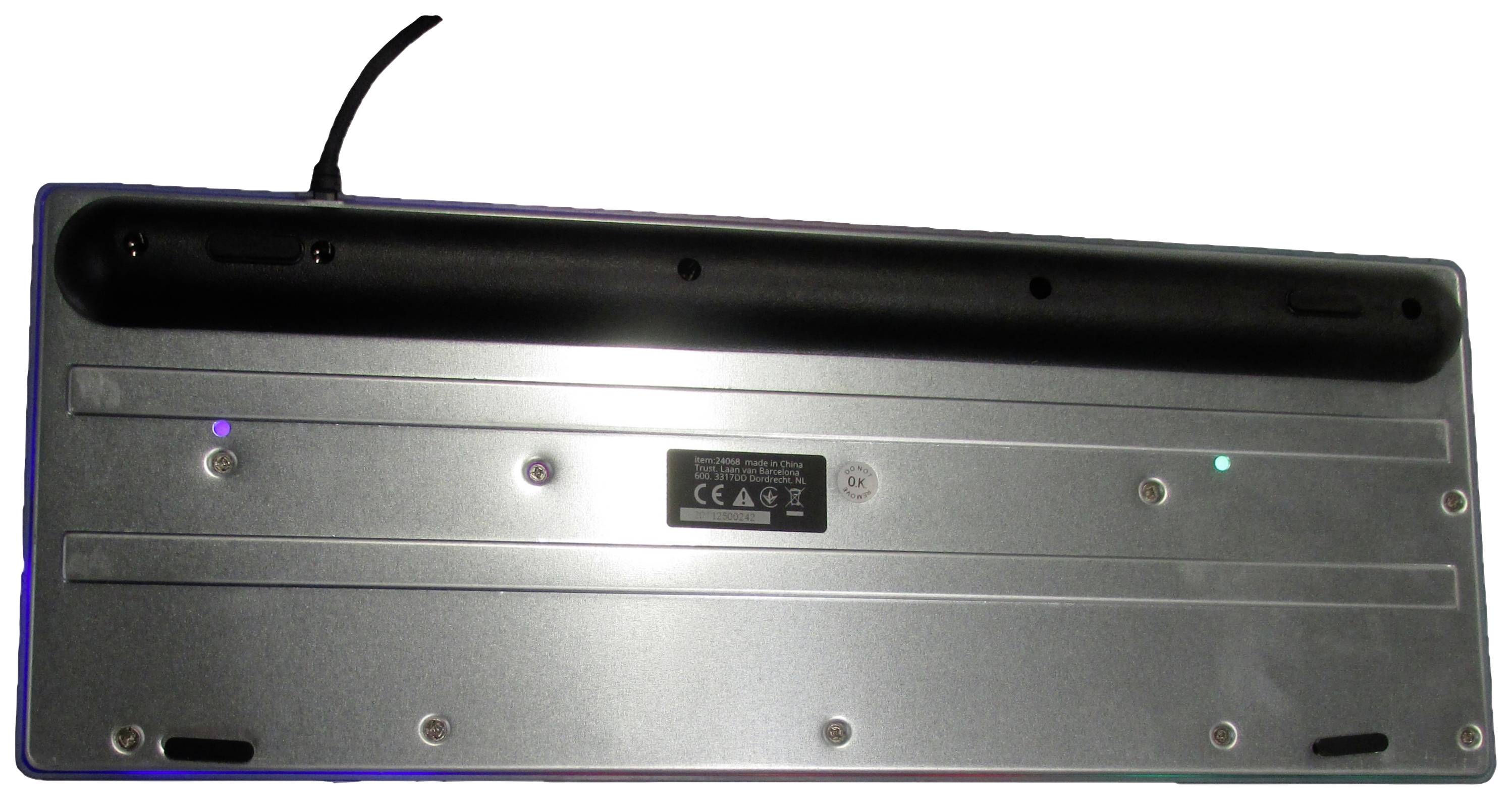 'Back of a mechanical keyboard with a detachable cable, non-slip rubber feet, and screws for securing the cover.'