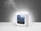 A white air humidifier is sitting on a table and emitting steam. Settings and an indicator are visible on the display.