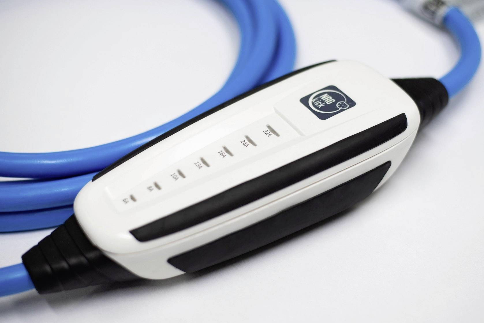 A white electric vehicle charging cable with a black handle and indicator light, connected to a blue cable on a white background.