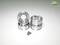 Four silver metal rims and a collection of small screws are arranged on a white background.