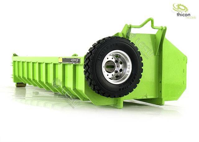 A green container with a large black wheel on the side, suitable for the transportation or storage of materials.