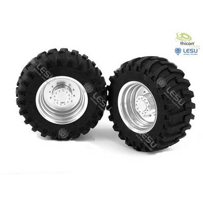 Two large, black tyres with deep tread and silver rims stand side by side on a white background.