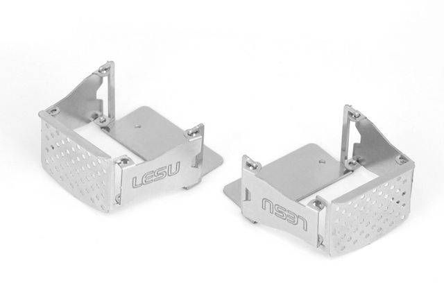 Two silver metal brackets with the inscription 'LESU', rectangular in shape, with perforated surfaces, positioned on a light background.