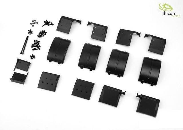 Black plastic parts and screws are laid out on a white background, seemingly for an assembly kit or model building.