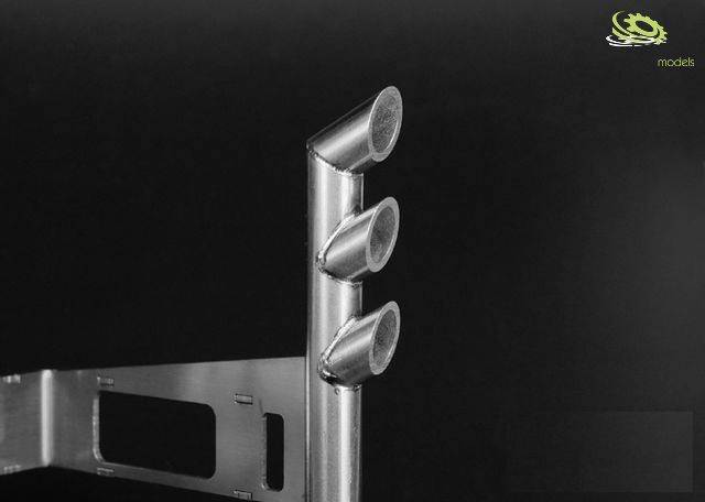 Three silver, slightly curved pipes arranged vertically against a black background, connected with a metal mounting bracket.