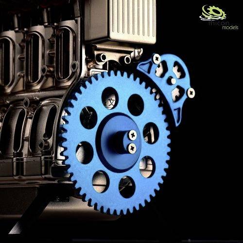 A metallic gear with other mechanical parts in close-up. Background blurred with focus on the blue gear.