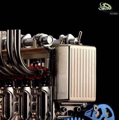 A detailed model of an engine, with metal components and hoses visible. Brand name located in the top right of the image.