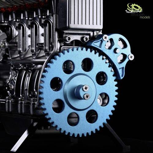 Close-up of a mechanical device with a large blue gear wheel and other metal components.