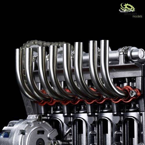 A highly detailed model of a V8 engine with visible exhaust manifolds and part of the ignition system.