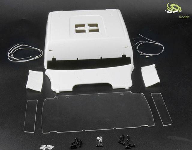 White model building components of a building's roof laid out on a black surface. Individual parts include roof, walls, transparent plate, and accessories.