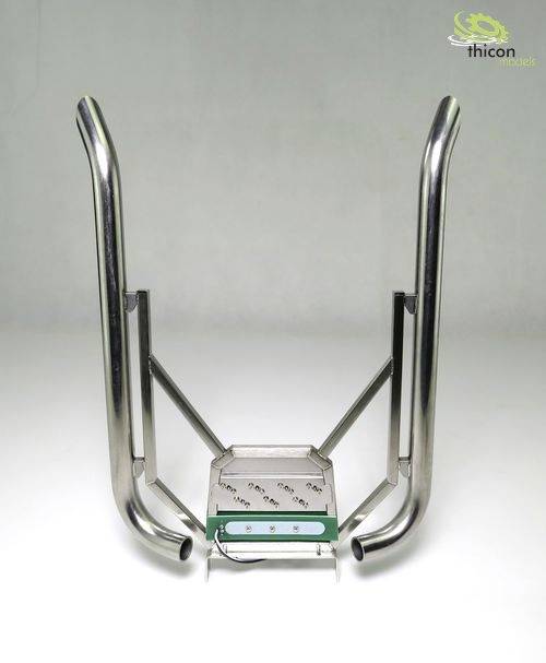 Metal frame with curved tubes and platform, possibly part of a device or machine, on a grey background.