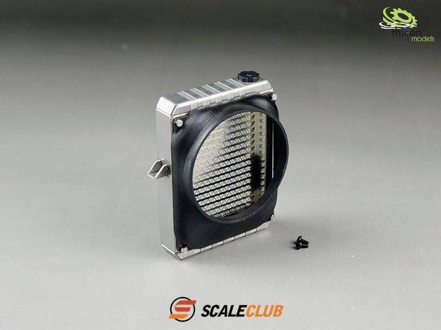 Radiator grille model part by ScaleClub. Silver frame with black front and ribbed structure. Screw positioned beside it on a grey background.