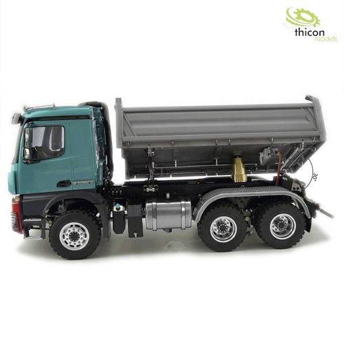 A blue tipper truck with its load bed raised, shown from the side. The 'thicon models' logo is visible in the top right corner.