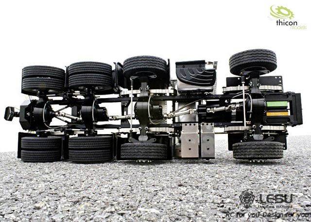 'Lorry chassis with multiple wheels and detailed mechanics on a gravel surface. The Thicon Models logo is visible in the top right corner.'