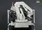 A metallic robotic arm with hydraulic components, mounted on a base, against a grey background.