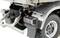 Close-up of a model lorry rear with detailed wheels and rear lights, silver metallic surface, and structured design.