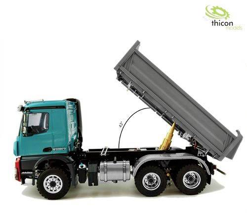 A model tipper truck with the lifting bed in the raised position. The green tractor unit stands on six wheels. Inscription: 'thicon models'.