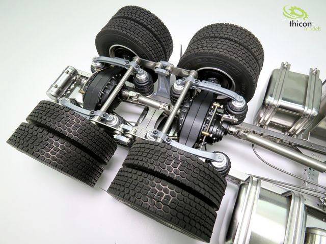 Model of a lorry chassis with six large wheels and visible suspension.