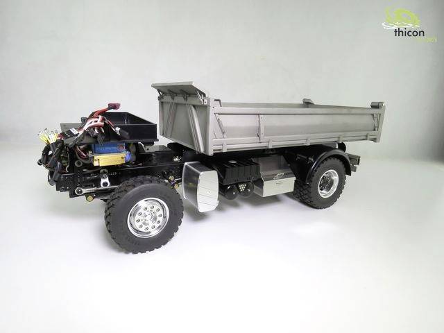 Toy truck model with tipper body on white background. Displays mechanical details and structural composition, suitable for model-building enthusiasts.